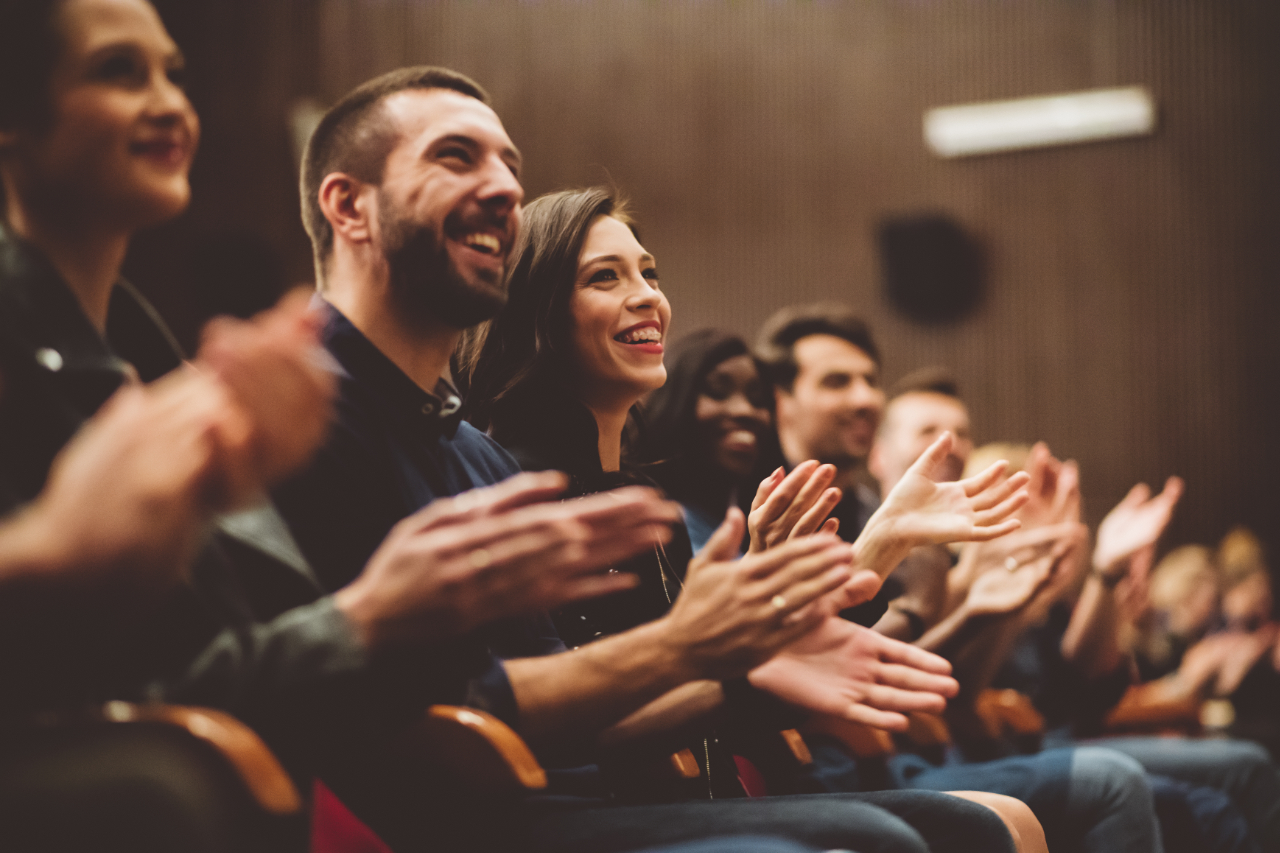 Happy audience applauding in the theater